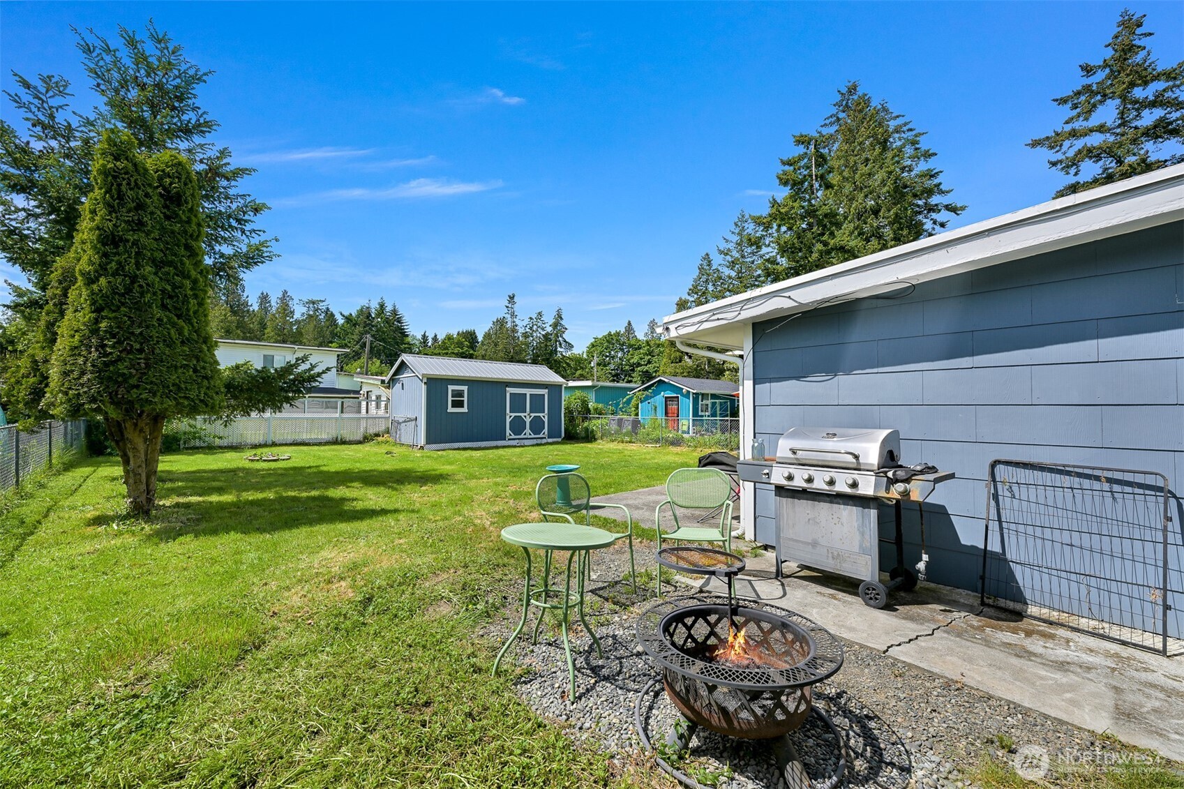 8153 Harborview Road Birch Bay, WA 98230 - Photo 23 of 28 a view of a chair and tables in the backyard