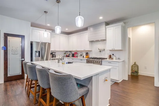 a large kitchen with a table and chairs
