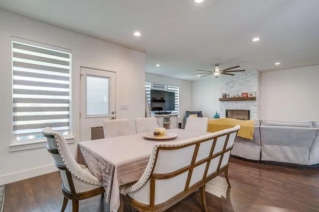 a kitchen with stainless steel appliances a stove a sink a oven a dining table and chairs