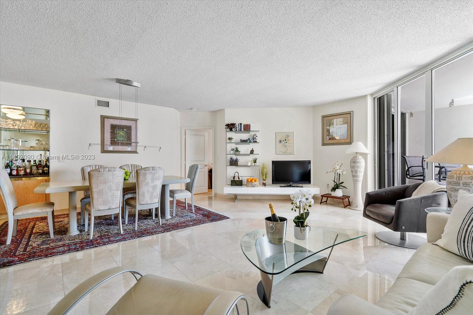 8925 Collins Avenue, Unit 9J Surfside, FL 33154 - Photo 11 of 41 a living room with furniture and wooden floor