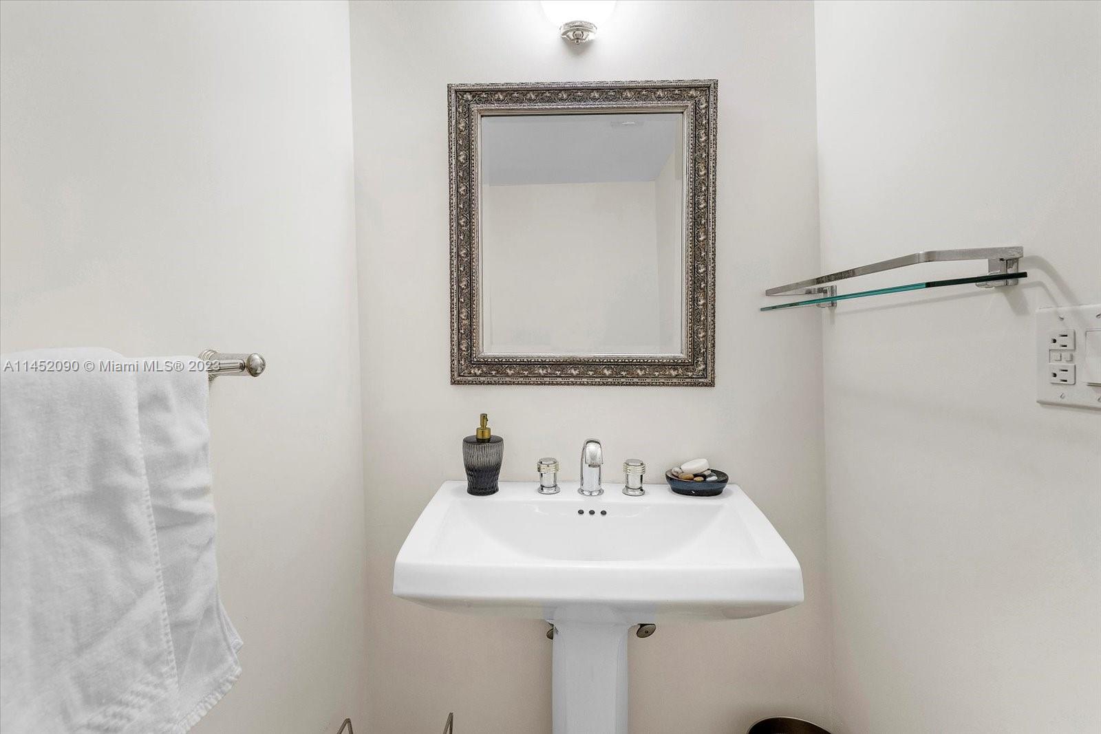 8925 Collins Avenue, Unit 9J Surfside, FL 33154 - Photo 15 of 41 a bathroom with a sink a mirror and shower
