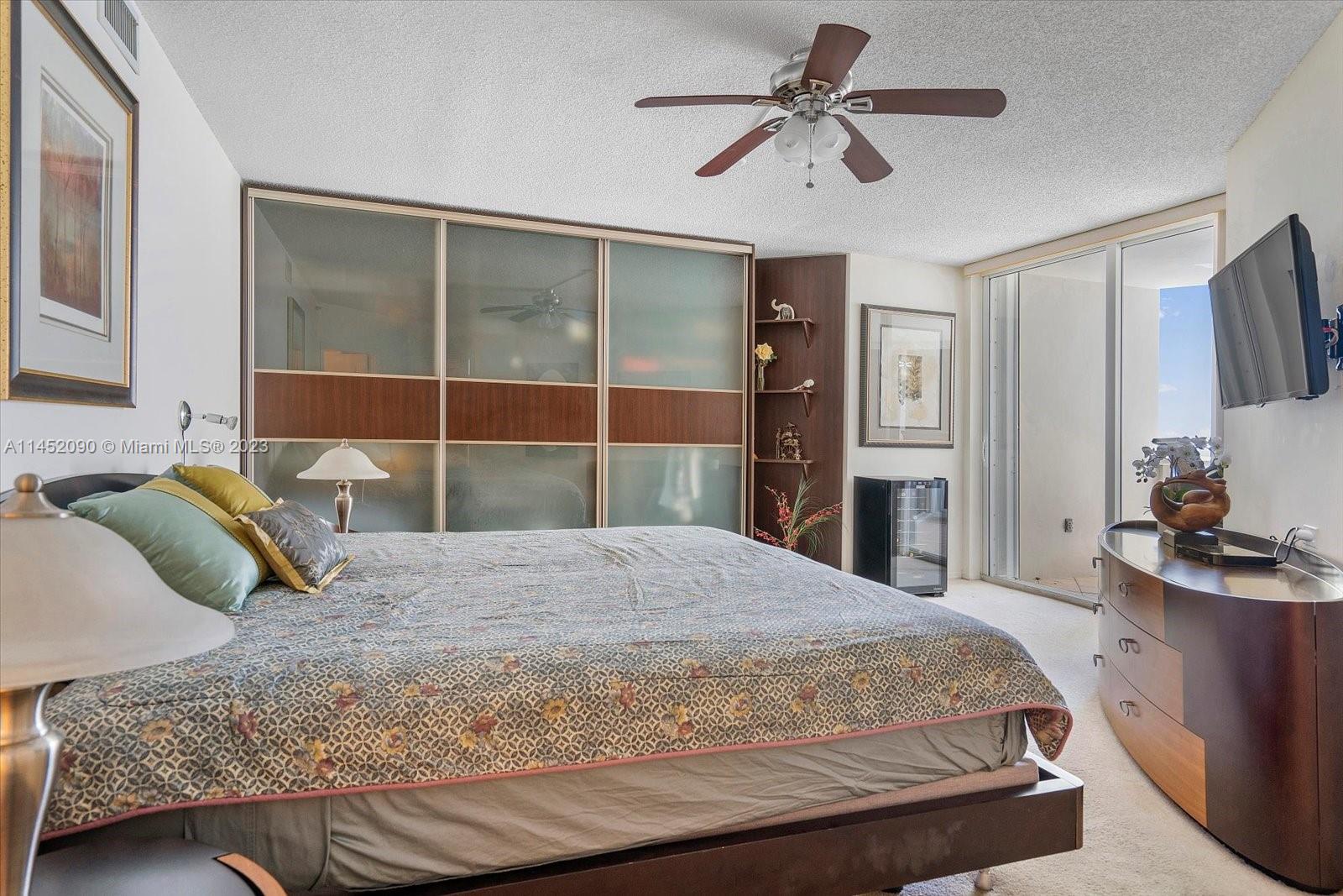 8925 Collins Avenue, Unit 9J Surfside, FL 33154 - Photo 16 of 41 a bedroom with a bed and a flat screen tv