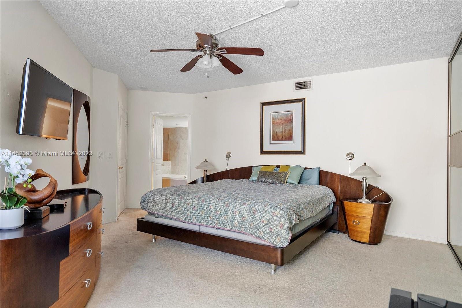 8925 Collins Avenue, Unit 9J Surfside, FL 33154 - Photo 18 of 41 a bedroom with a bed and cabinets