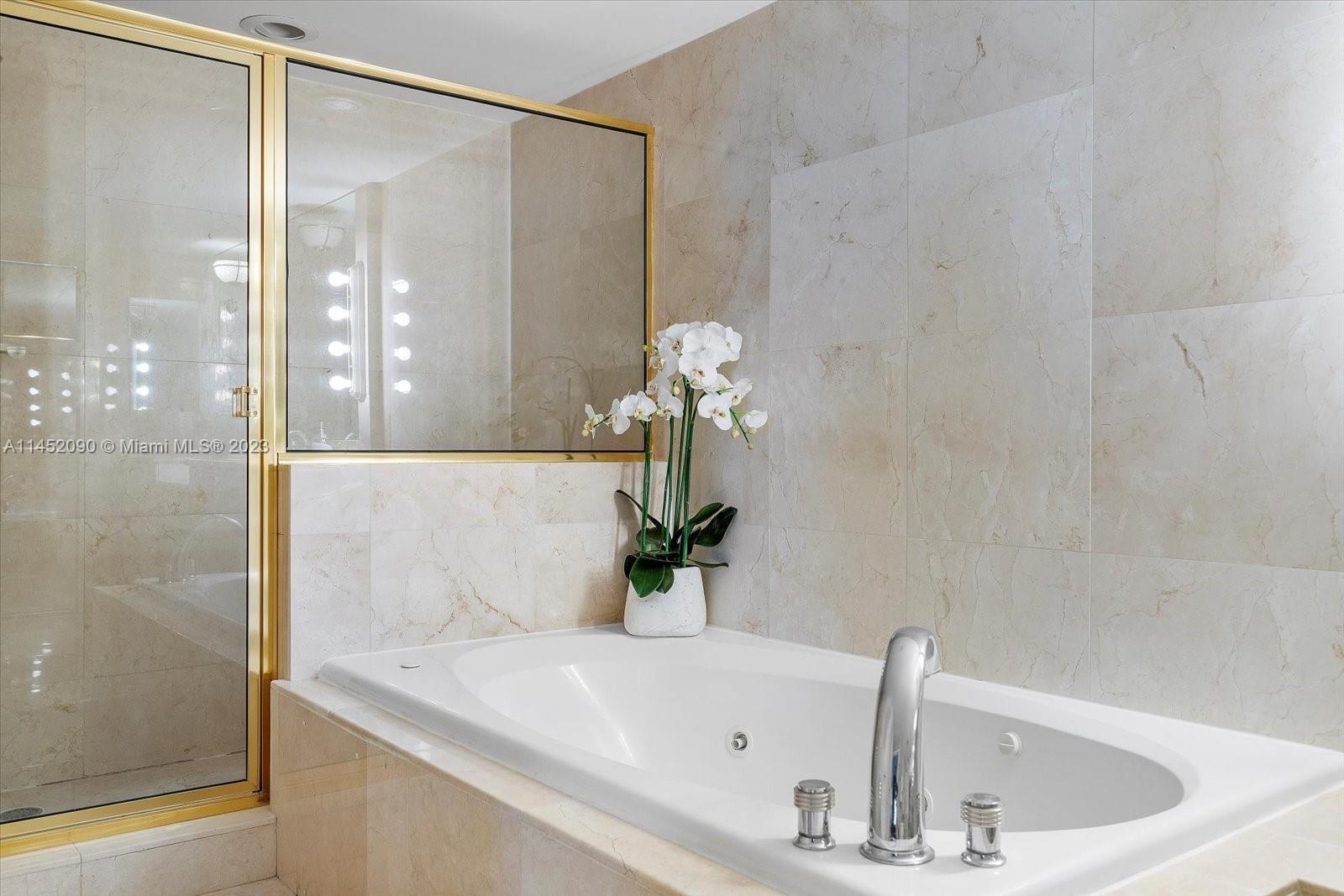 8925 Collins Avenue, Unit 9J Surfside, FL 33154 - Photo 21 of 41 a bathroom with a sink and a mirror