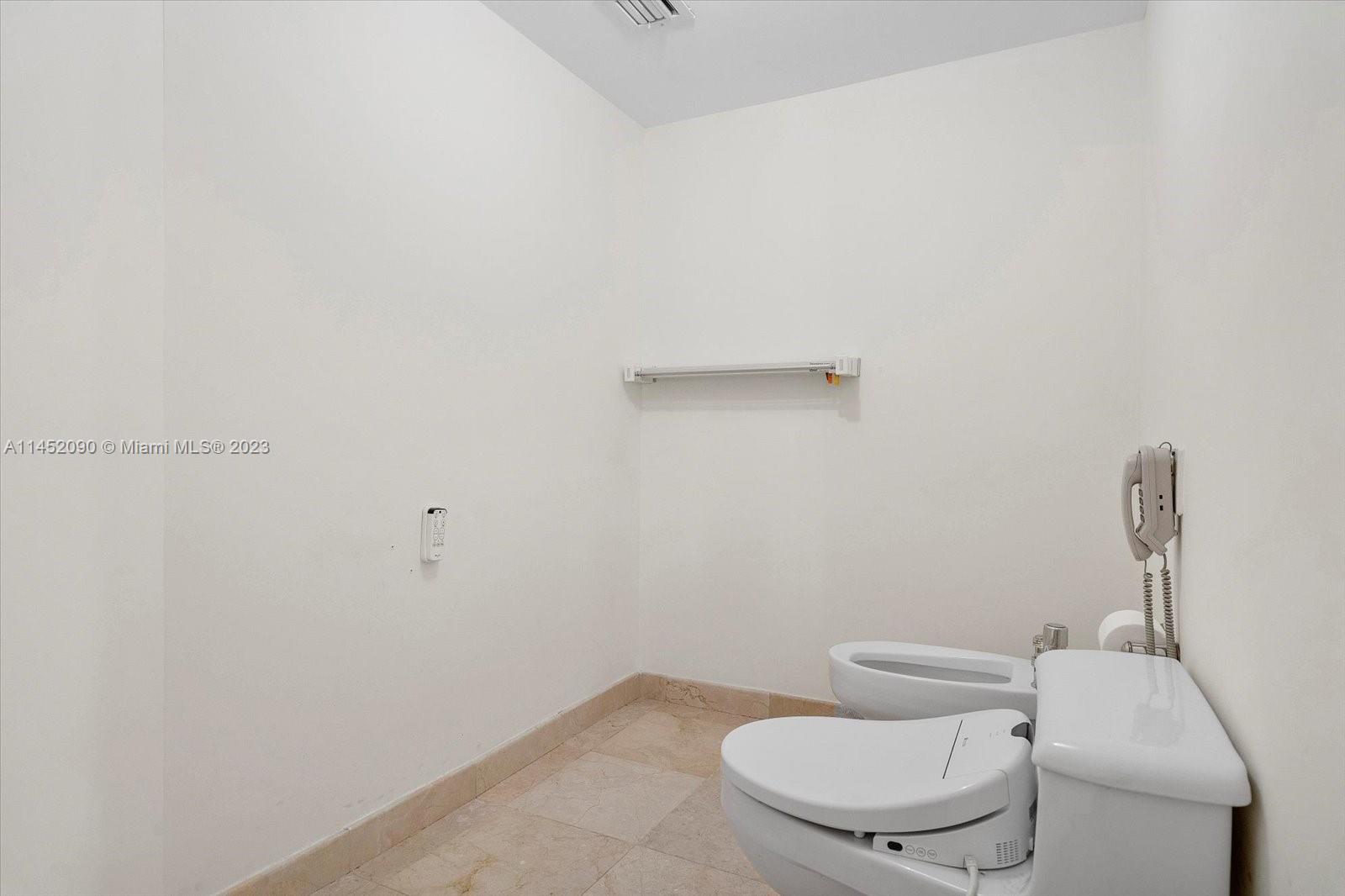 8925 Collins Avenue, Unit 9J Surfside, FL 33154 - Photo 22 of 41 a white toilet sitting next to a shower