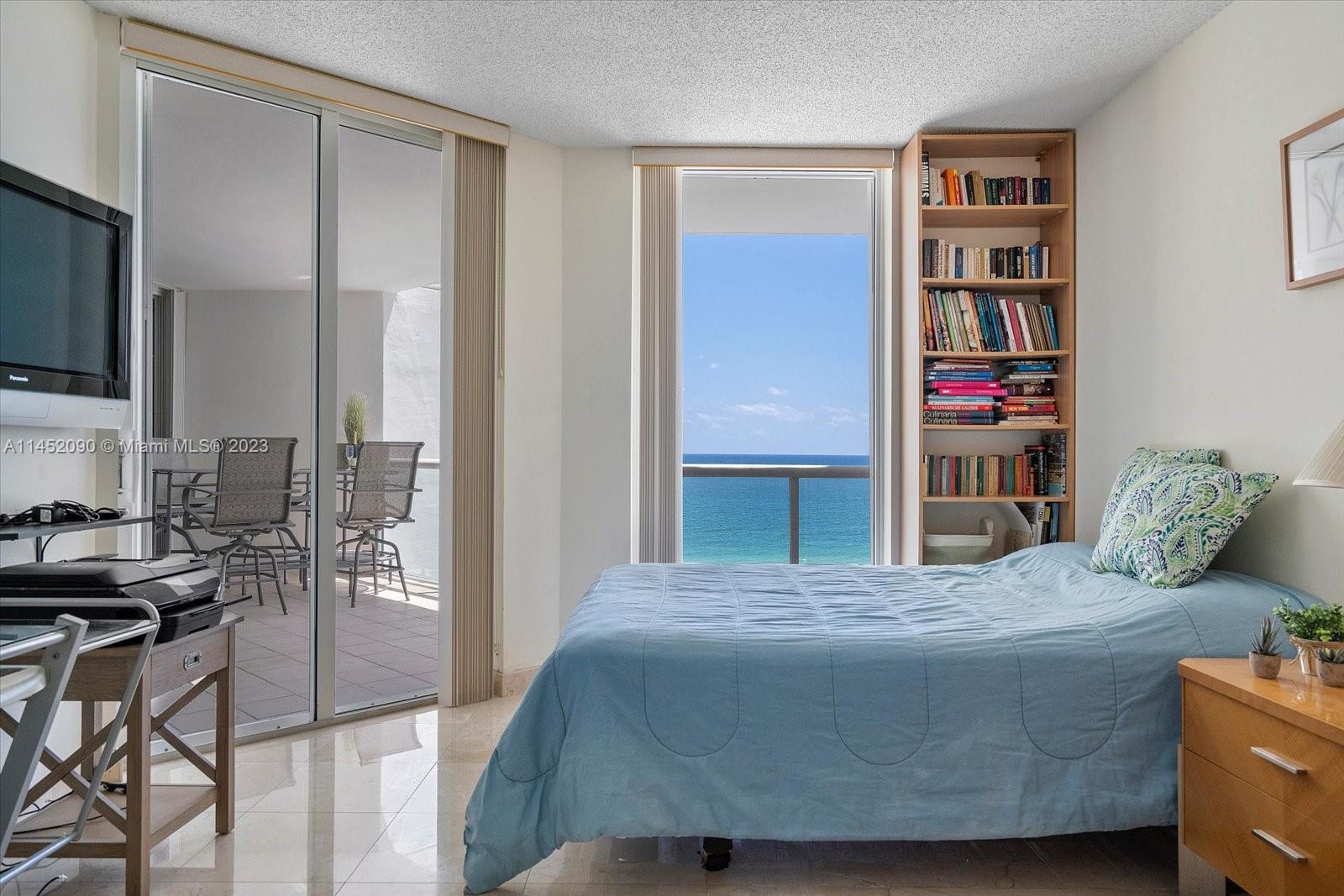 8925 Collins Avenue, Unit 9J Surfside, FL 33154 - Photo 23 of 41 a living room with a couch and a flat screen tv