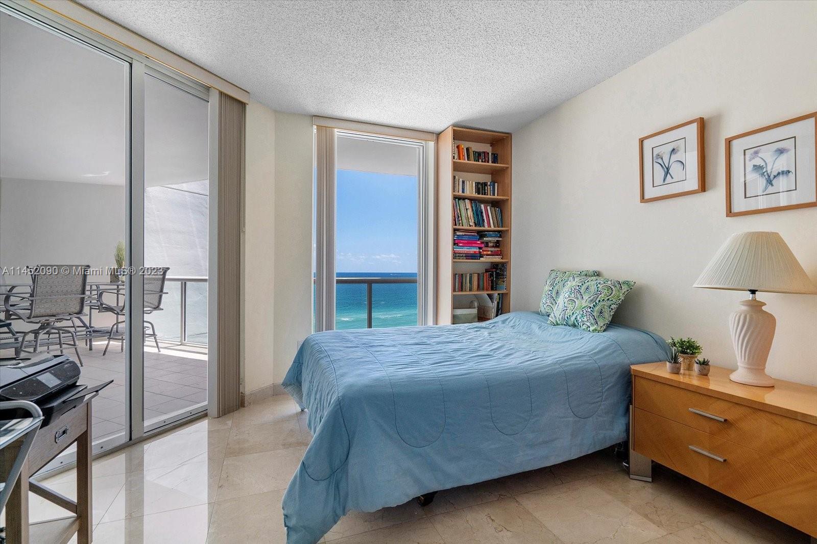 8925 Collins Avenue, Unit 9J Surfside, FL 33154 - Photo 24 of 41 a bedroom with a bed and a cabinets