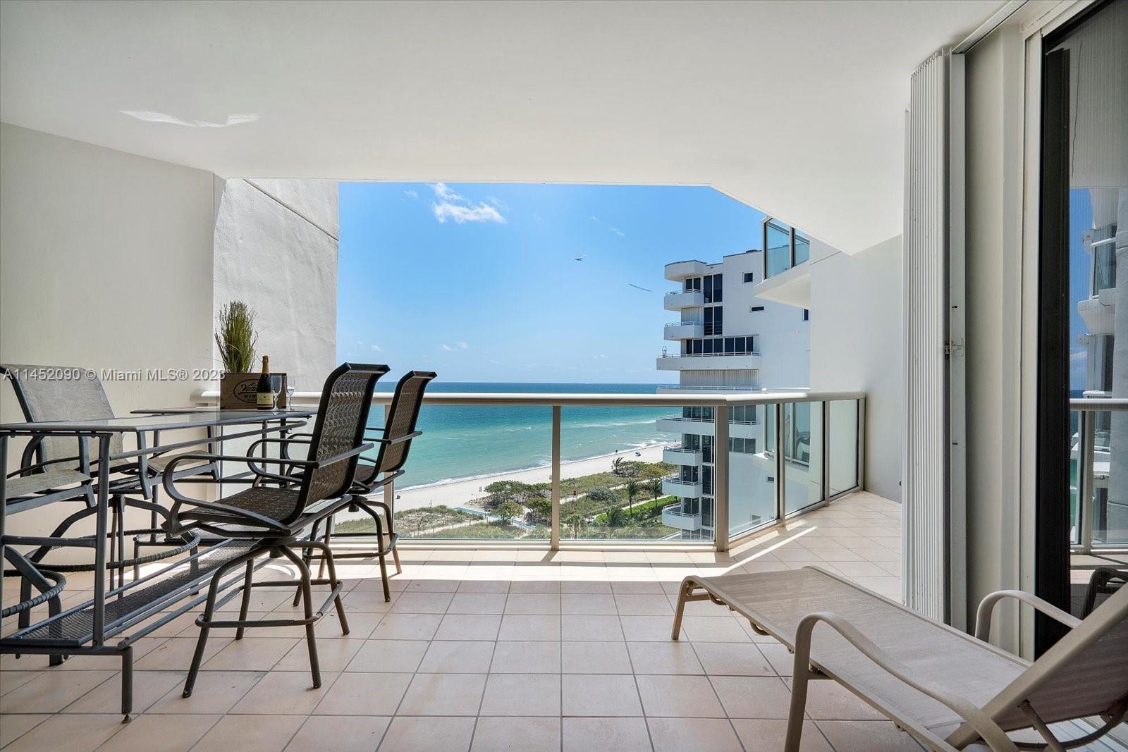 8925 Collins Avenue, Unit 9J Surfside, FL 33154 - Photo 26 of 41 a dining room with furniture and a floor to ceiling window