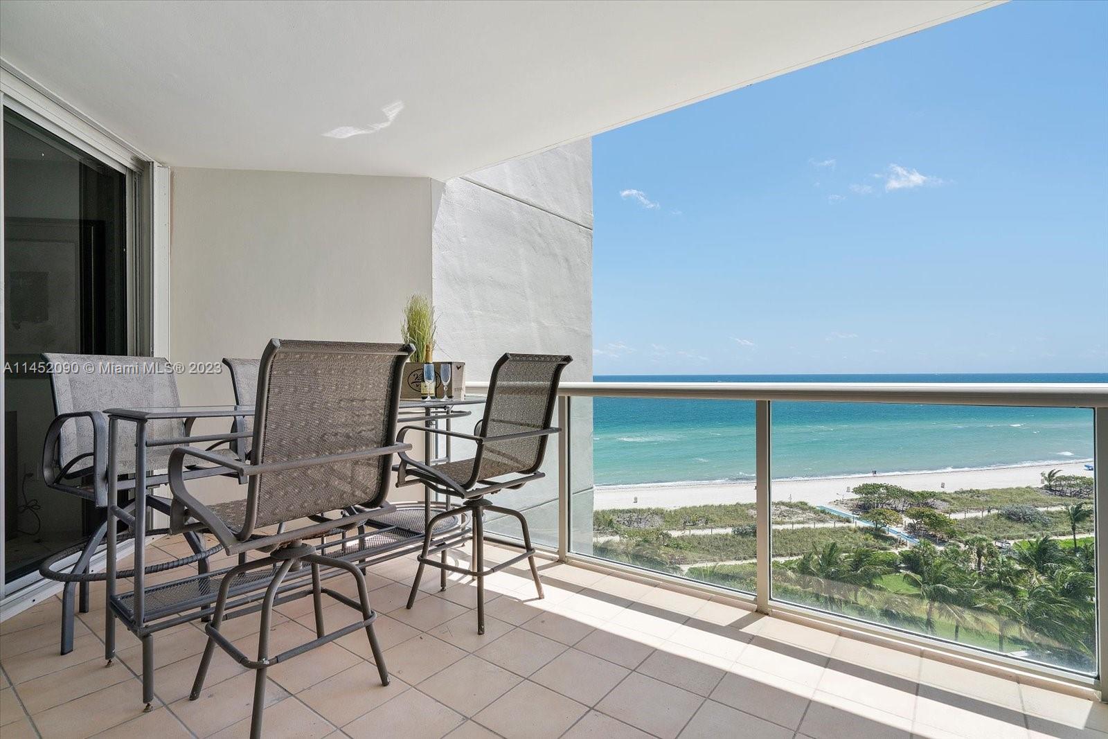 8925 Collins Avenue, Unit 9J Surfside, FL 33154 - Photo 27 of 41 a view of a city from a dining room with furniture and floor to ceiling window