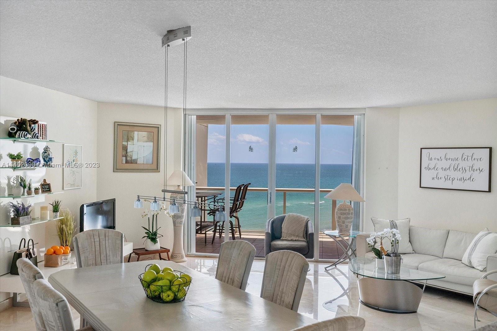 8925 Collins Avenue, Unit 9J Surfside, FL 33154 - Photo 3 of 41 a living room with furniture and a table