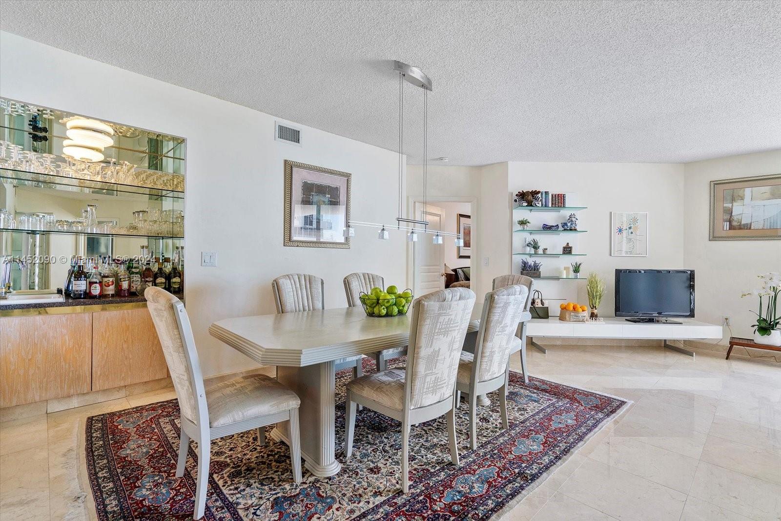 8925 Collins Avenue, Unit 9J Surfside, FL 33154 - Photo 7 of 41 a dining room with furniture and wooden floor