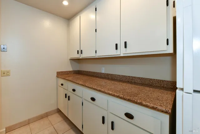 a view of cabinets with granite countertop wooden cabinets