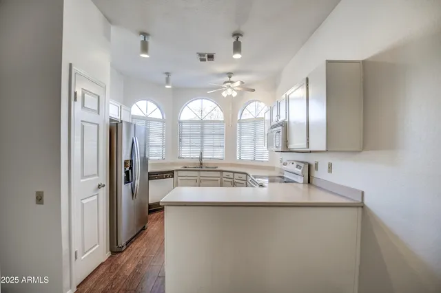 a bathroom with a sink mirror and a shower