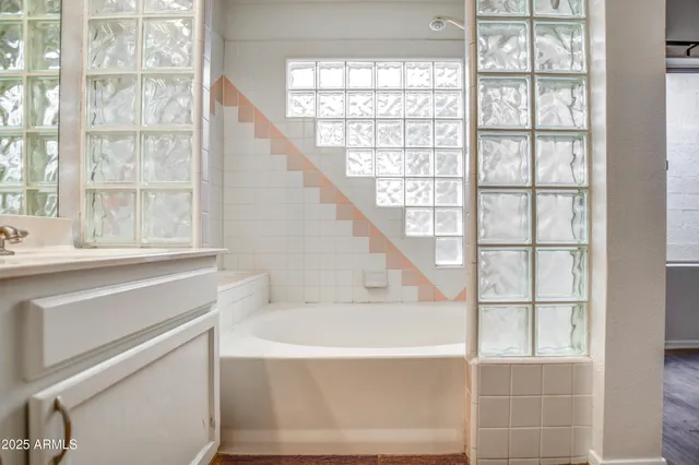 a bathroom with sink and a large window