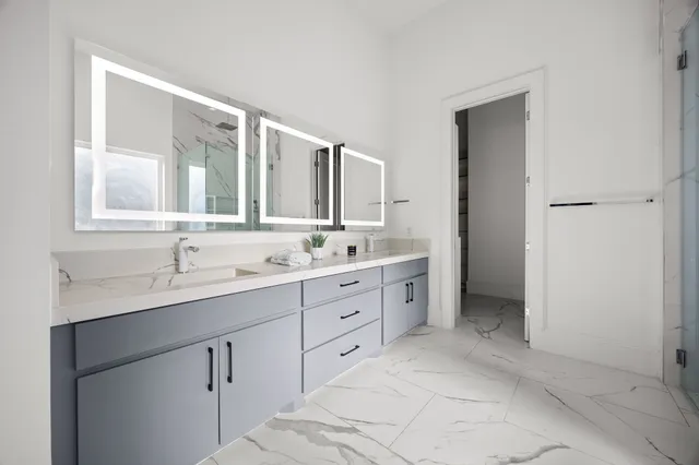 a spacious bathroom with a double vanity sink mirror and double