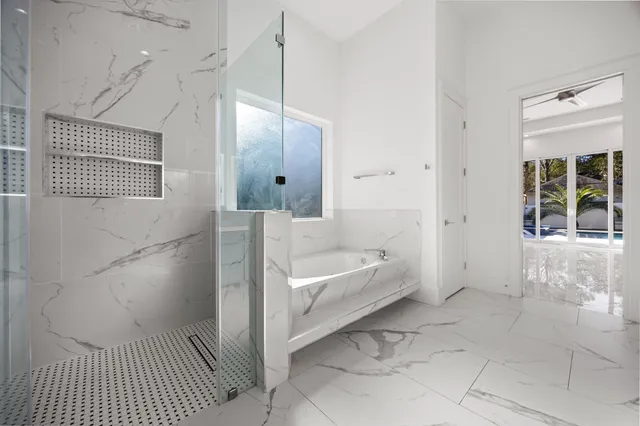 a bathroom with a bathtub and a shower