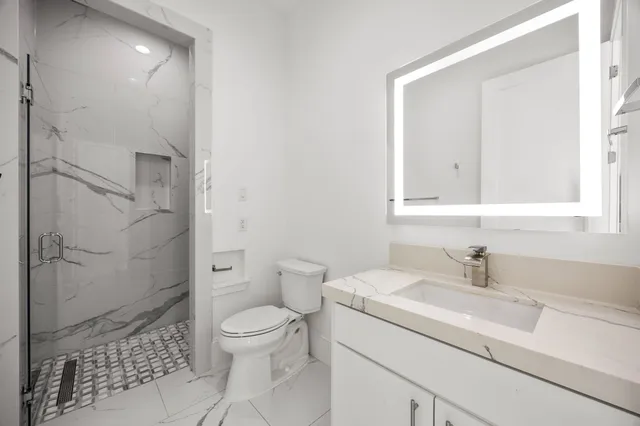a bathroom with a sink toilet and shower