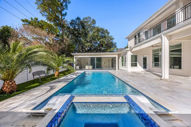 a view of a house with backyard and sitting area