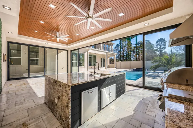 a kitchen with granite countertop a sink and a stove