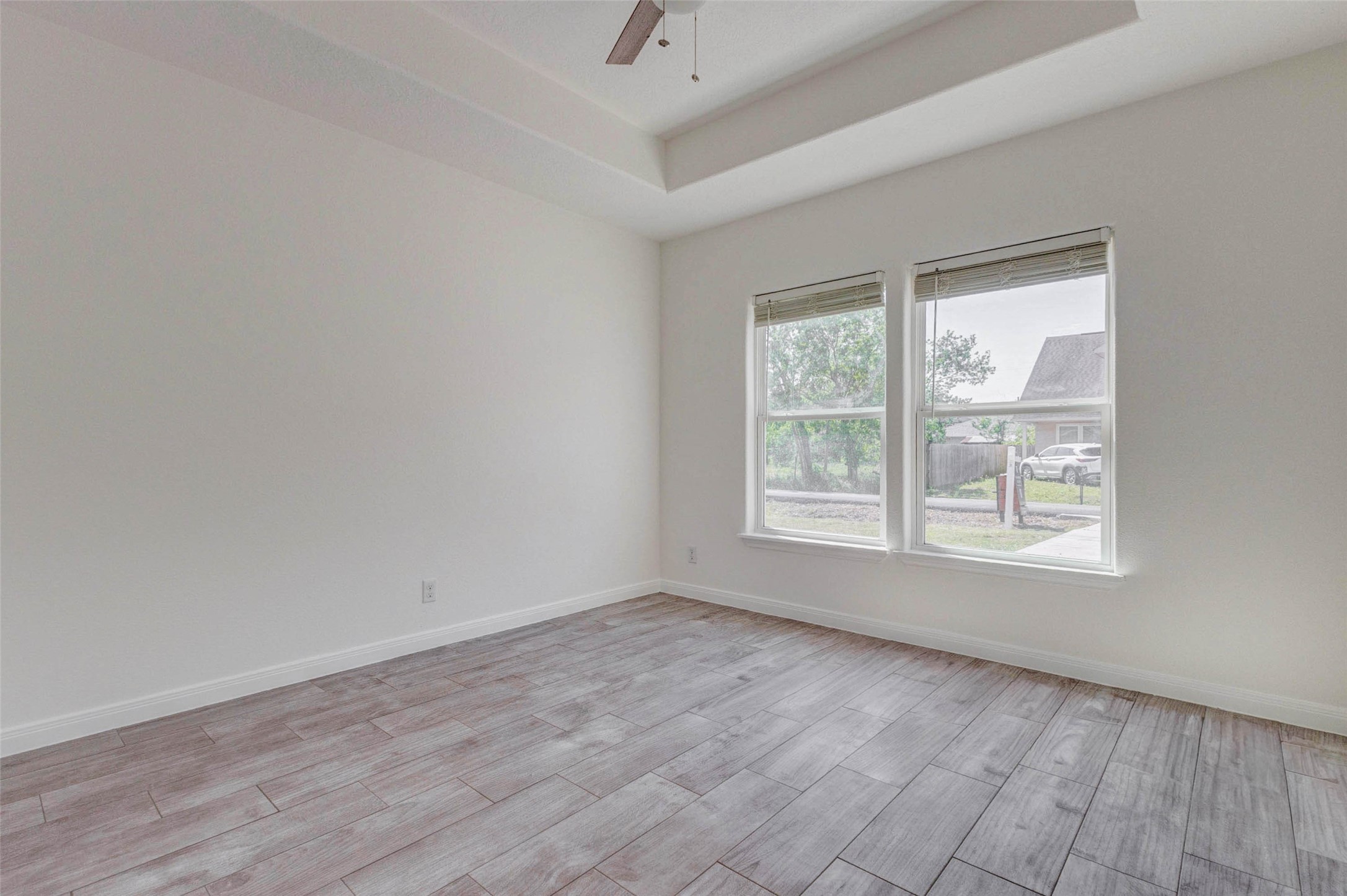 9811 Kerr Street Houston, TX 77029 - Photo 17 of 22 Another angle of the secondary bedroom highlighting its generous space and abundant natural light. The room’s layout allows for versatile furniture placement, while the modern finishes provide a clean and updated feel. Perfect for family, guests, or a comfortable workspace.