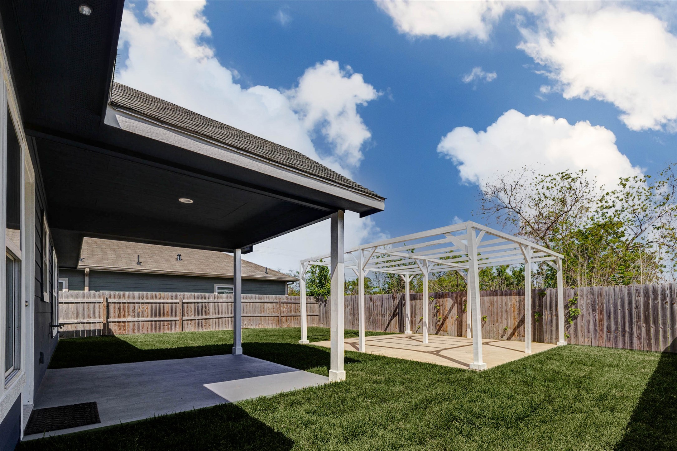 9811 Kerr Street Houston, TX 77029 - Photo 19 of 22 Enjoy outdoor living at its finest with a covered patio perfect for relaxing in the shade, paired with a charming pergola ideal for entertaining or creating your own outdoor retreat. The fully fenced backyard offers privacy and plenty of space for pets, play, or gatherings. Whether hosting a barbecue or enjoying a quiet evening, this backyard is designed for comfort and versatility.