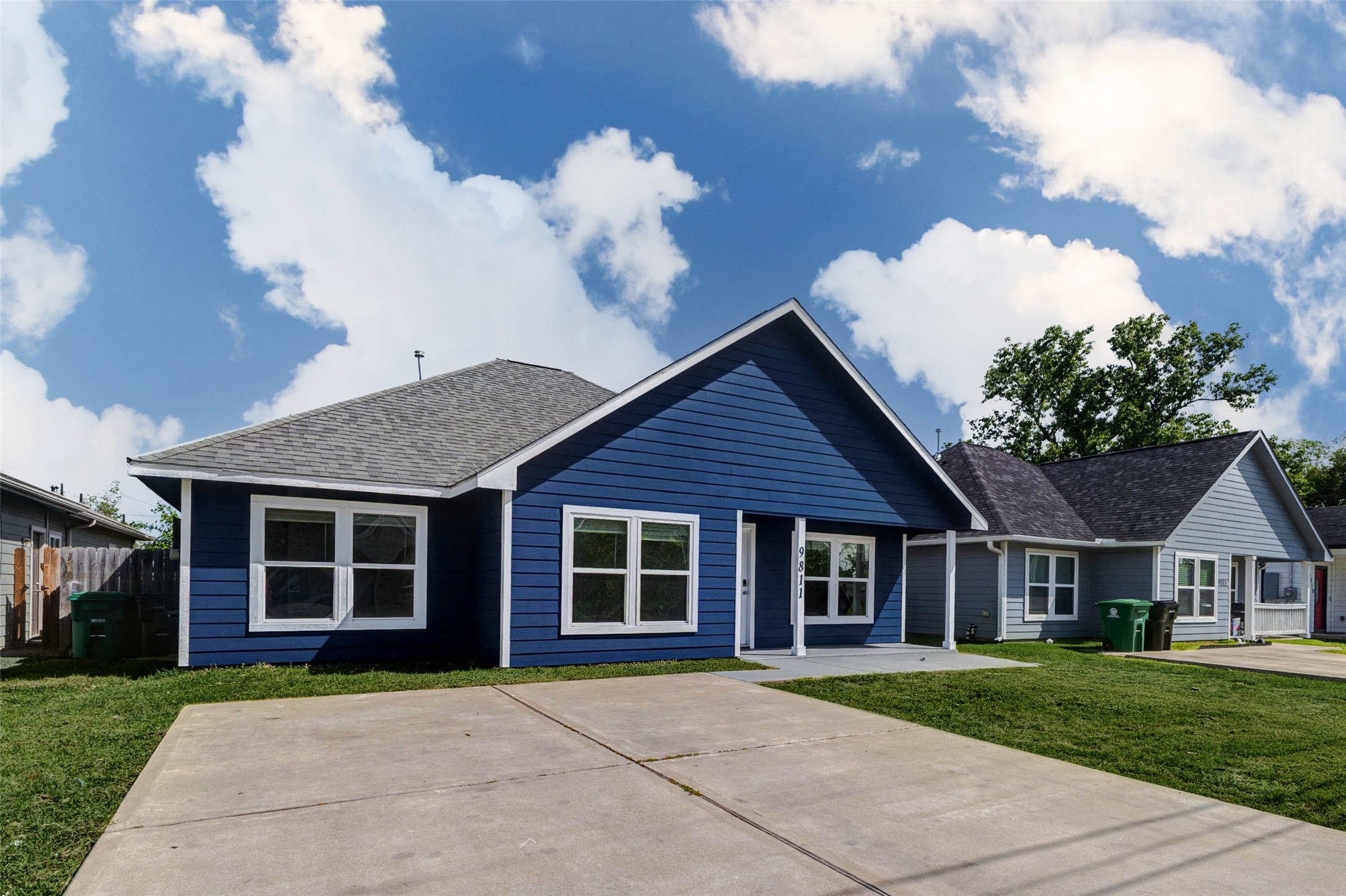 9811 Kerr Street Houston, TX 77029 - Photo 22 of 22 Spacious driveway and wide front yard provide plenty of room for parking and outdoor activities. The home’s bold exterior color palette stands out beautifully against the neighborhood, while the covered porch adds both style and function. This angle highlights the generous frontage and practical layout, offering convenience and curb appeal in one attractive package.