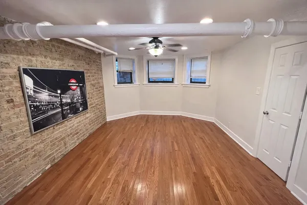 wooden floor in an empty room with a fireplace