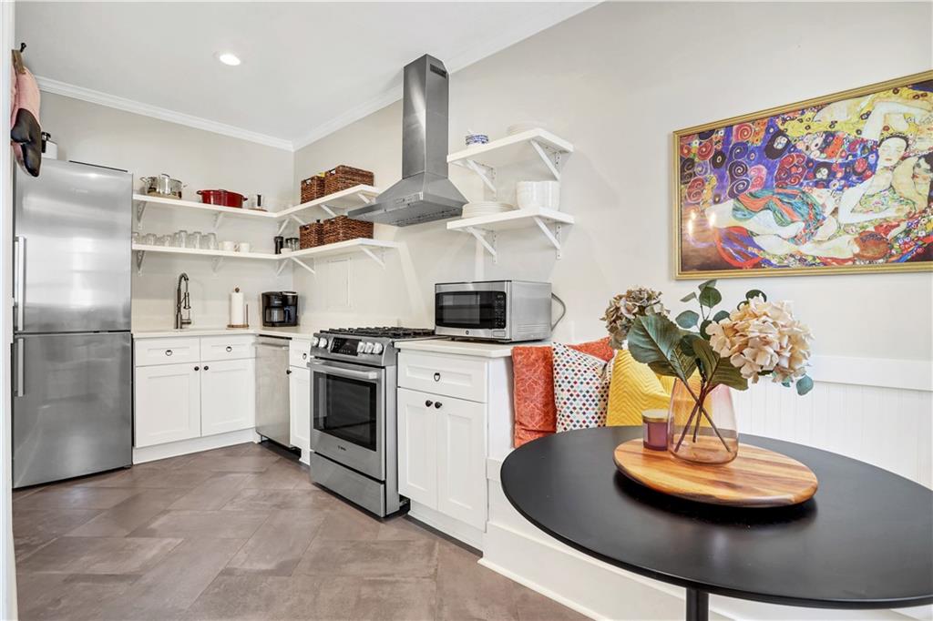 a kitchen with stainless steel appliances granite countertop a sink and a stove with white countertops