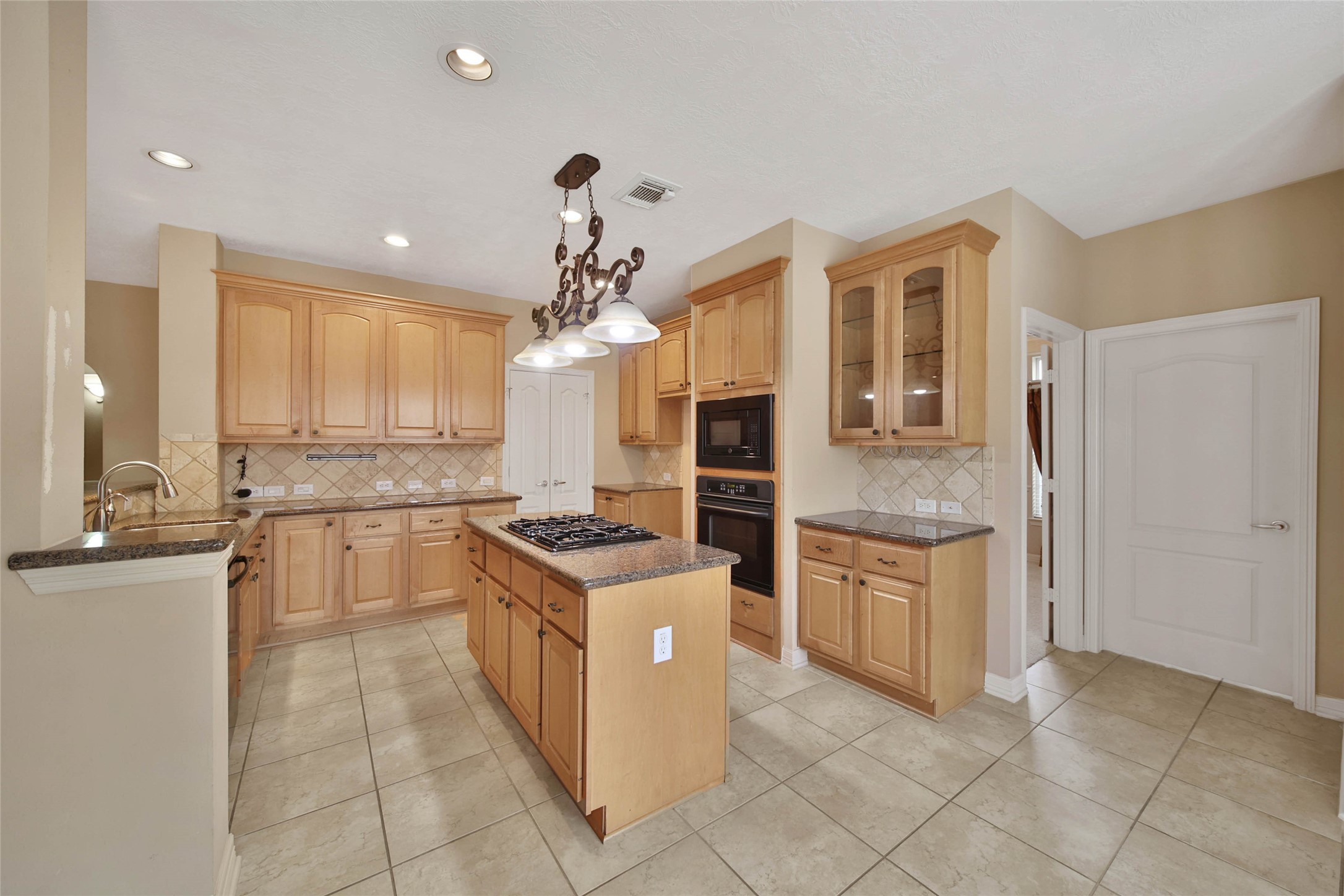 6530 Monte Bello Ridge Lane Houston, TX 77041 - Photo 11 of 43 a kitchen with a stove a sink and a refrigerator