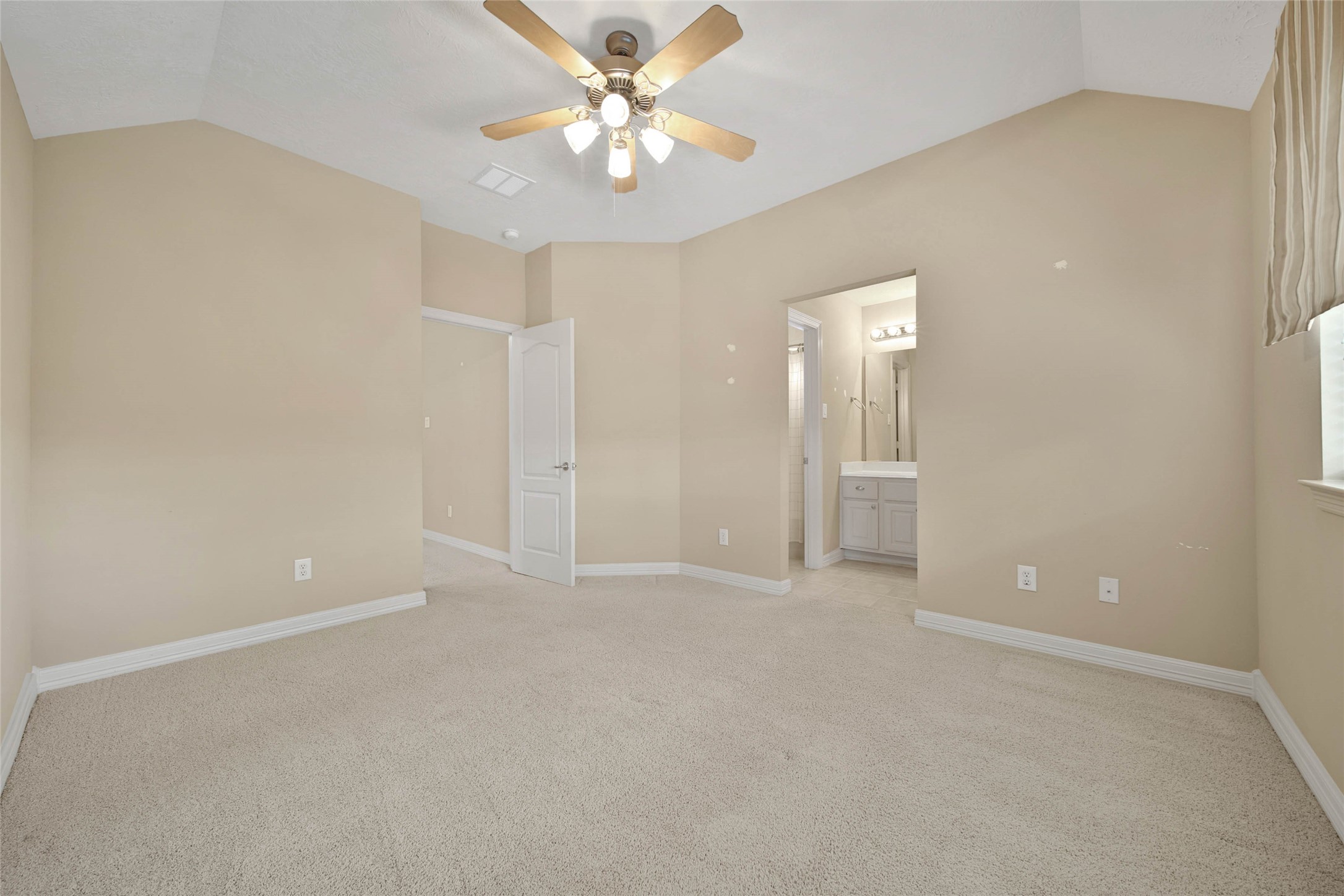 6530 Monte Bello Ridge Lane Houston, TX 77041 - Photo 31 of 43 an empty room with a ceiling fan and a window