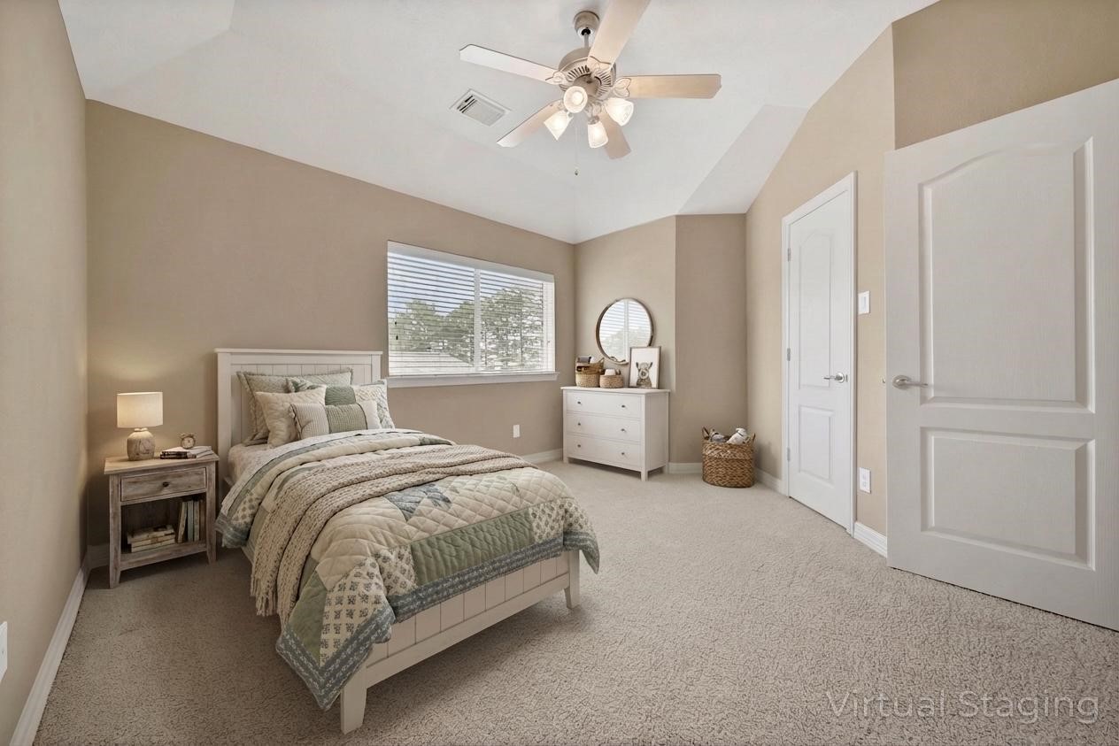 6530 Monte Bello Ridge Lane Houston, TX 77041 - Photo 34 of 43 a spacious bedroom with a large bed and a chandelier
