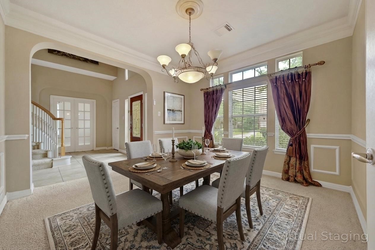 6530 Monte Bello Ridge Lane Houston, TX 77041 - Photo 7 of 43 a dining room with wooden floor a chandelier a wooden table and chairs