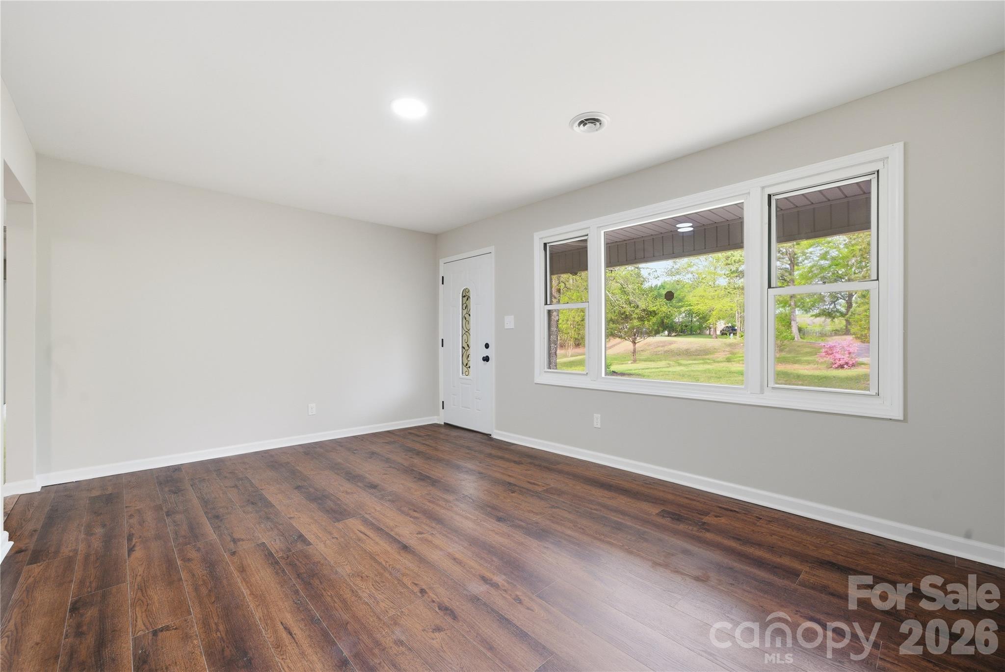 3285 Douglas Way Lane Lancaster, SC 29720 - Photo 11 of 44 a view of an empty room with wooden floor and a window