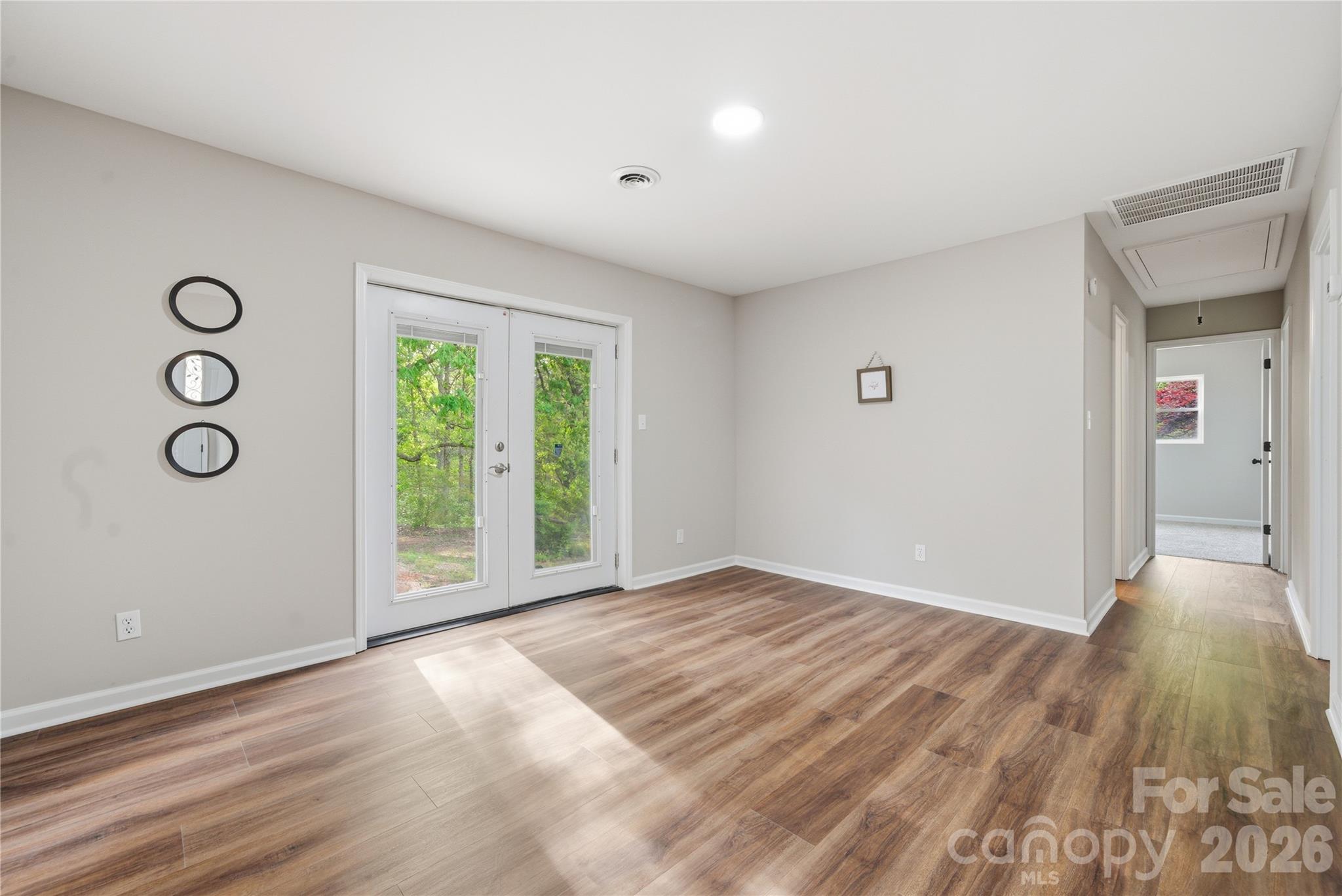 3285 Douglas Way Lane Lancaster, SC 29720 - Photo 12 of 44 a view of an empty room with wooden floor and a window