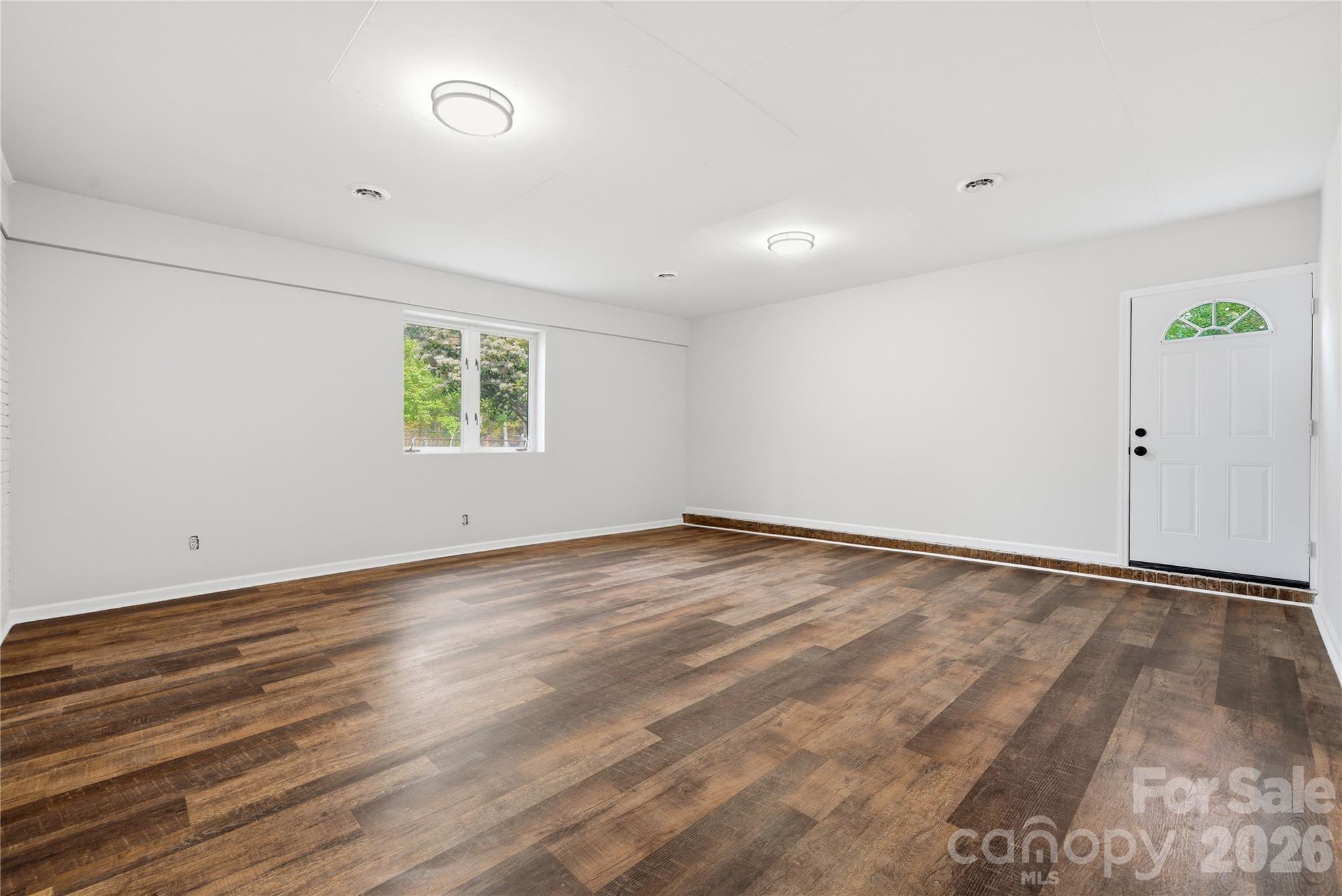 3285 Douglas Way Lane Lancaster, SC 29720 - Photo 29 of 44 an empty room with wooden floor and windows