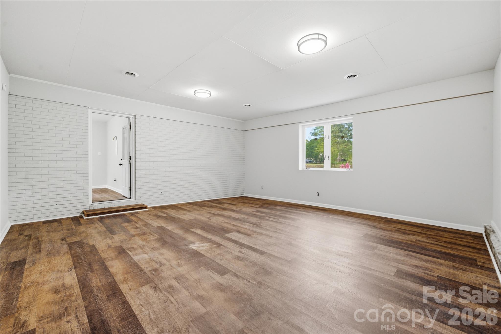 3285 Douglas Way Lane Lancaster, SC 29720 - Photo 30 of 44 a view of an empty room with wooden floor and a window