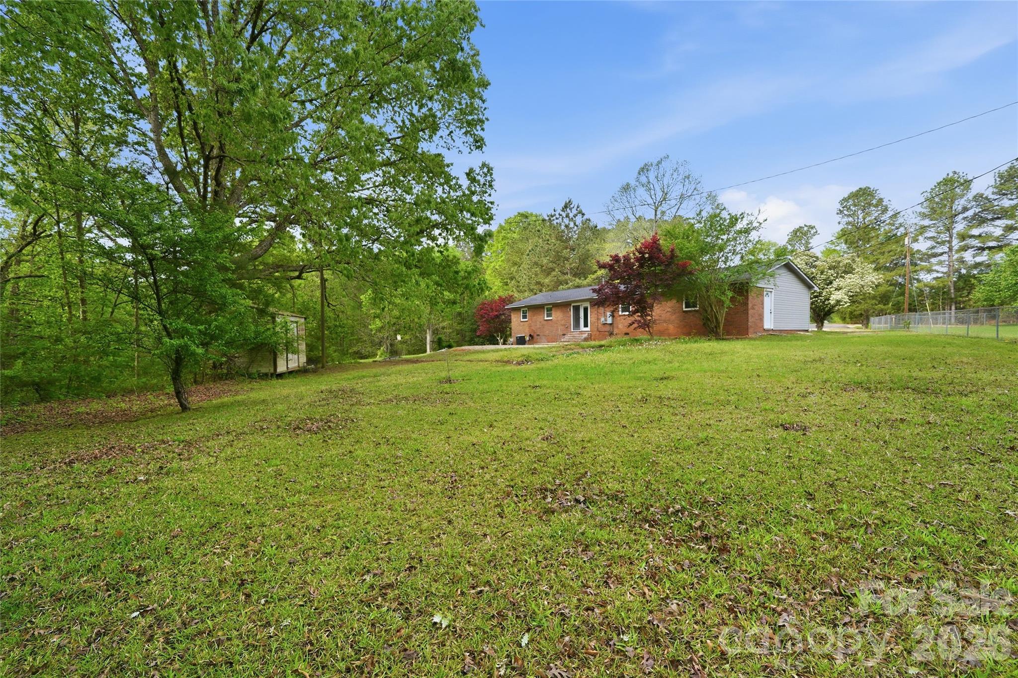 3285 Douglas Way Lane Lancaster, SC 29720 - Photo 34 of 44 a backyard of a house with lots of green space and fountain