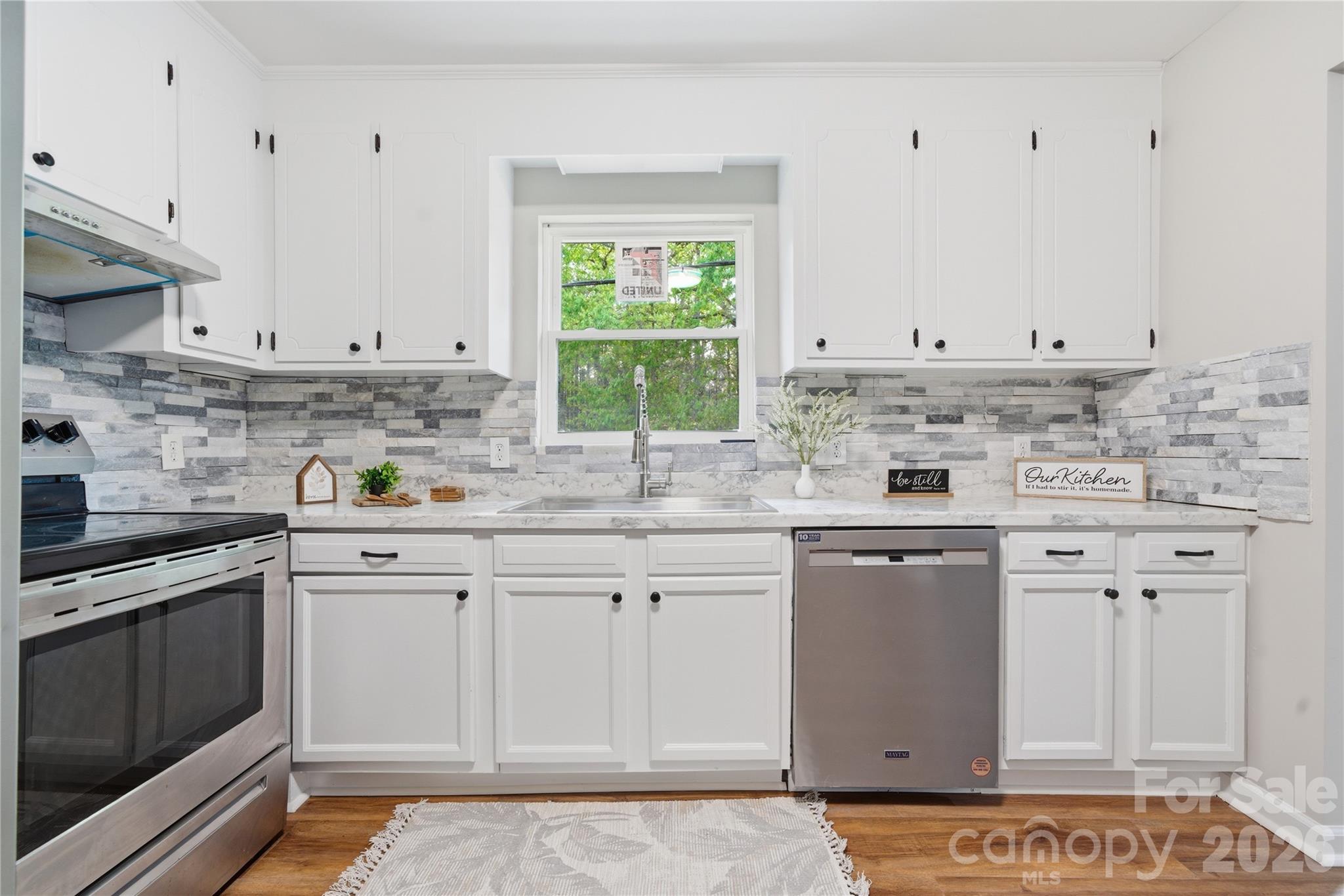 3285 Douglas Way Lane Lancaster, SC 29720 - Photo 5 of 44 a kitchen with granite countertop white cabinets and white appliances