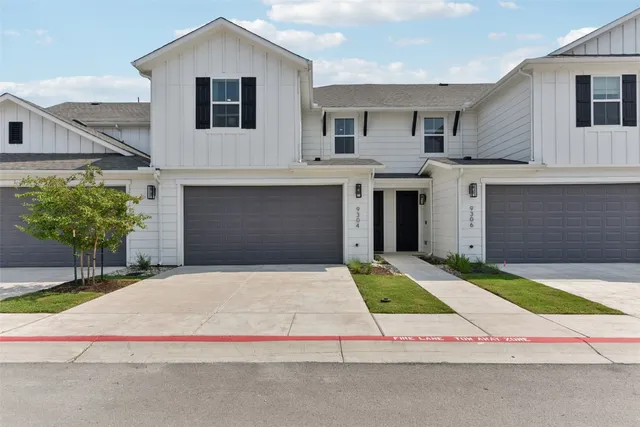 a house with yard and a large parking space