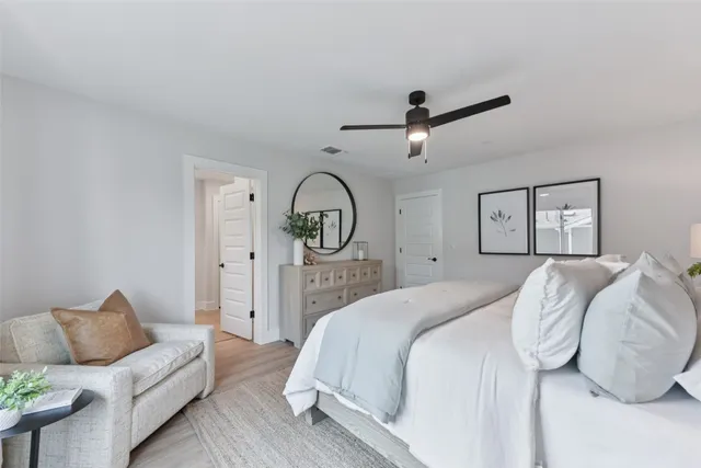 a bedroom with bed and a large window