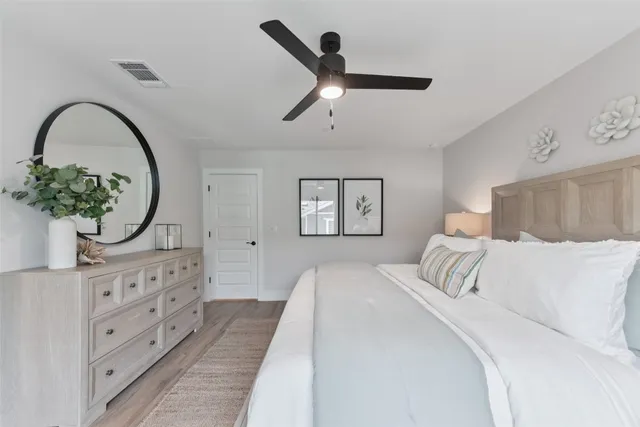 a bedroom with a large bed and a window