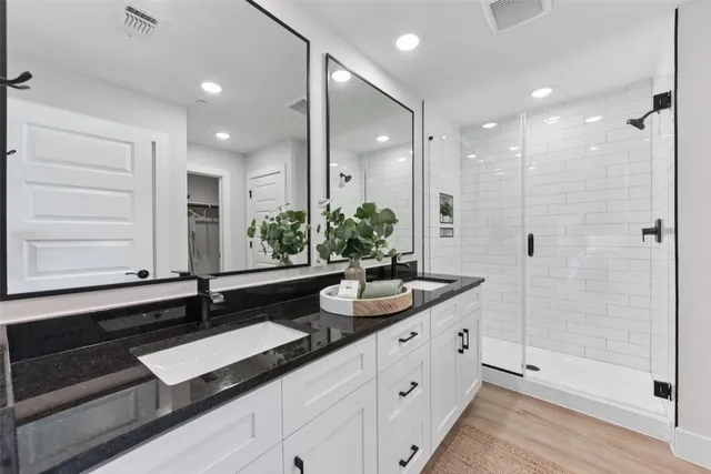 a spacious bedroom with a bed a couch and a chandelier