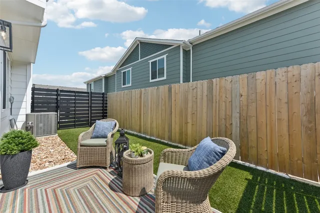 a view of two chairs in the patio