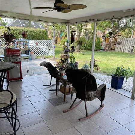 a view of a porch with furniture and a yard