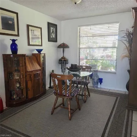a dining room with furniture and window