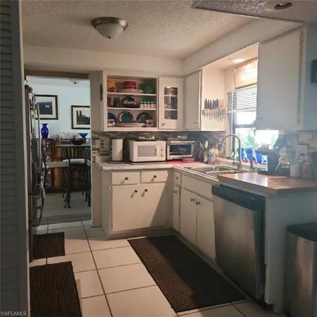 a kitchen with a sink appliances and cabinets