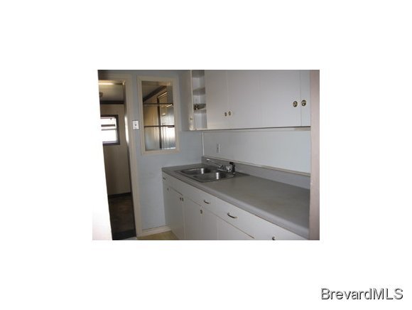 1119 Northeast Jordan Palm Bay, FL 32905 - Photo 9 of 12 a kitchen with a sink and cabinets
