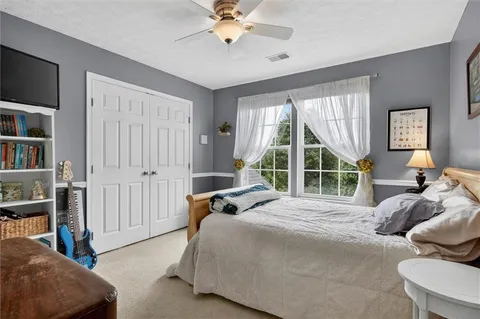 a spacious bedroom with a bed and a window
