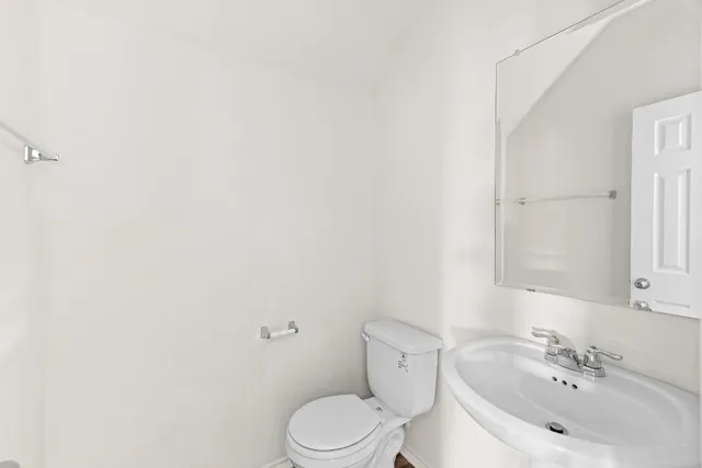 a white toilet sitting next to a bathroom sink