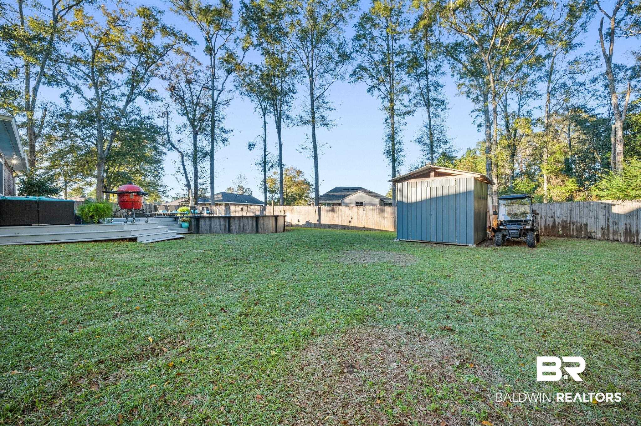 9366 Fox Run Court Semmes, AL 36575 - Photo 26 of 29 View of yard featuring a shed and a pool side deck